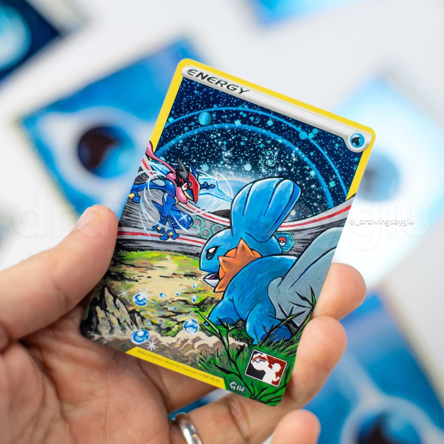 Hand-painted Mudkip vs Ash Greninja on Pokémon card by Giu Magnani.