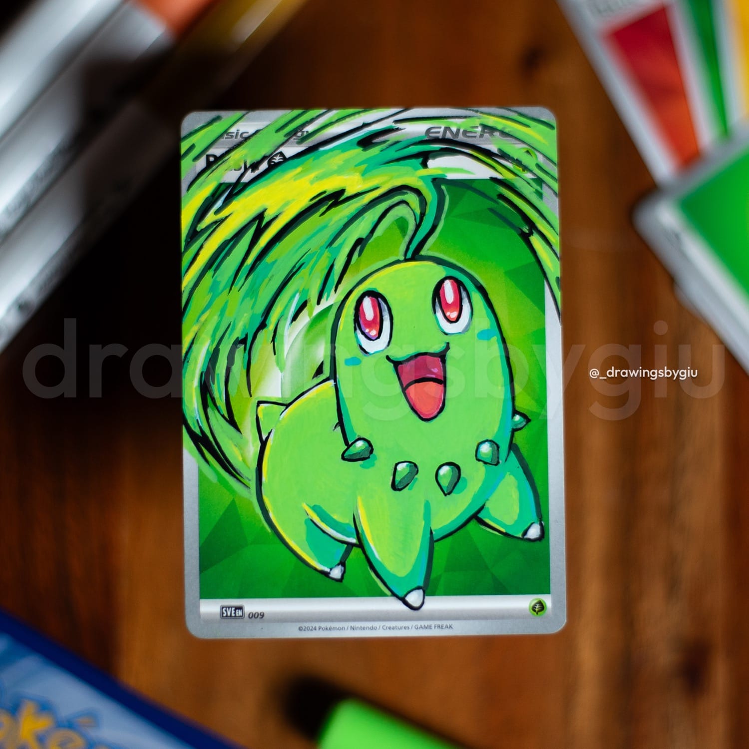 Hand-painted Chikorita on Pokémon card by Giu Magnani.